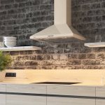 At what height above gas stoves are hoods hung?