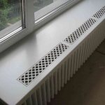 Several ventilation grilles in the window sill above the radiator