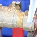 installing a ball valve on a metal pipe picture